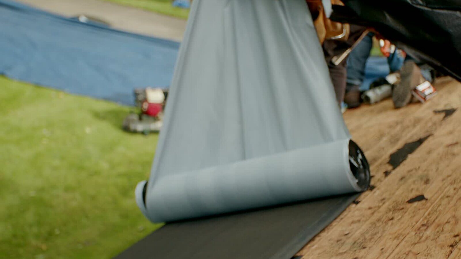 Roofing underlayment being rolled out during a Twin Cities exterior restoration project.