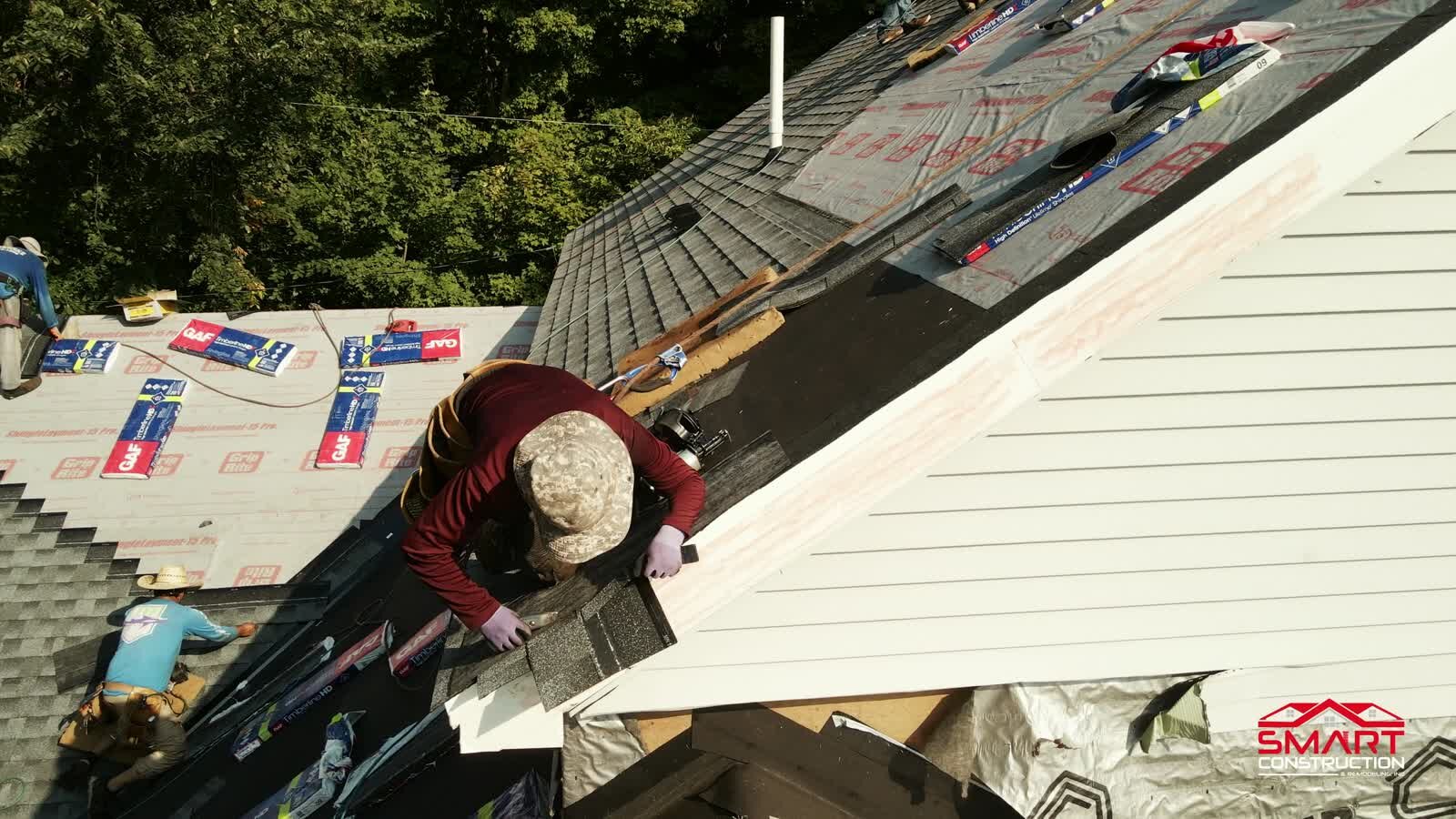 Smart Construction crew installing roof shingles during a Twin Cities roof replacement.